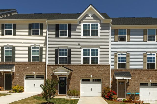 a front view of a house with many windows