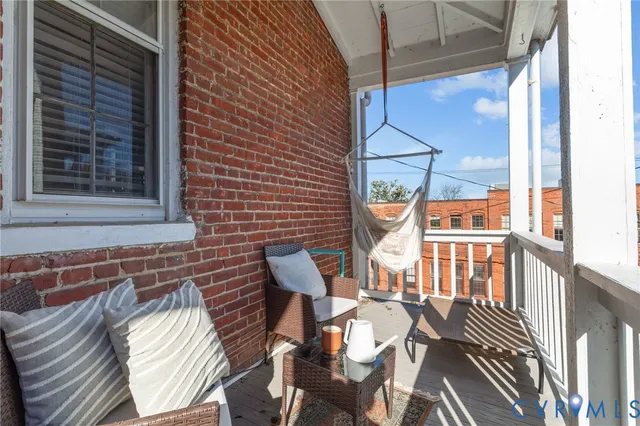 a view of a patio with table and chairs and wooden floor