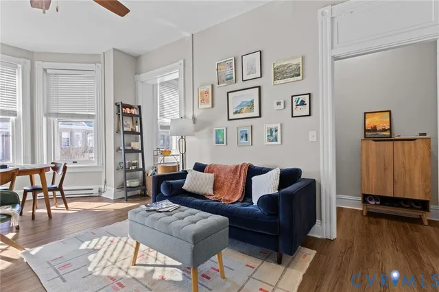 a living room with furniture and wooden floor