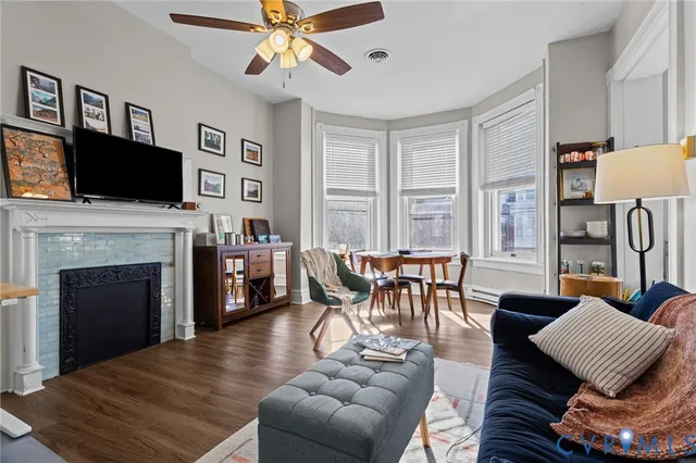 a living room with furniture a flat screen tv and a fireplace