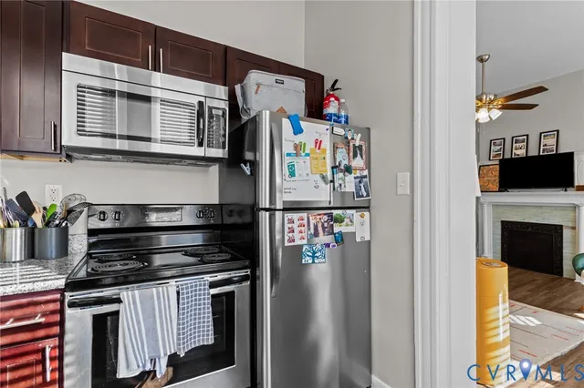 a kitchen with stainless steel appliances granite countertop a stove and a refrigerator