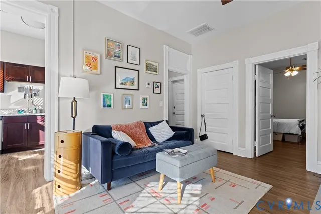 a living room with furniture and wooden floor