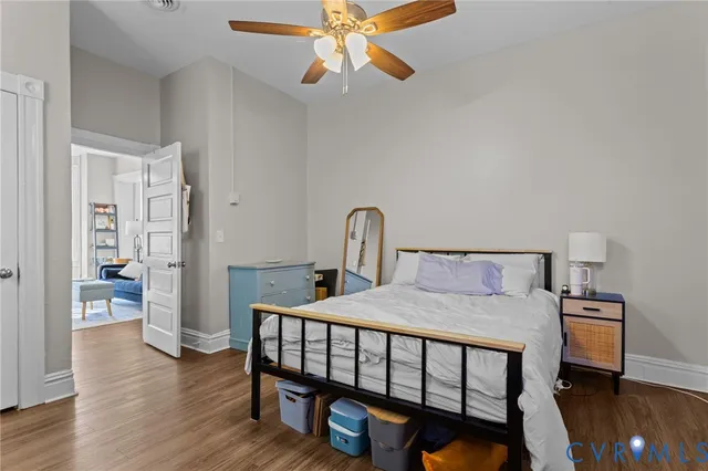 a bedroom with a bed and wooden floor