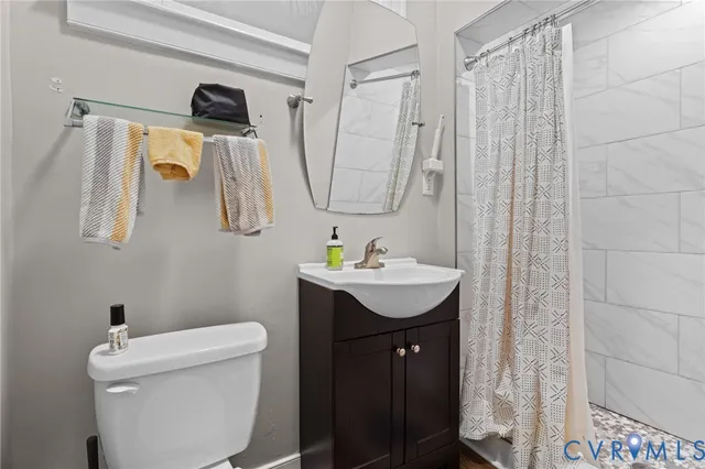 a bathroom with a sink toilet and mirror
