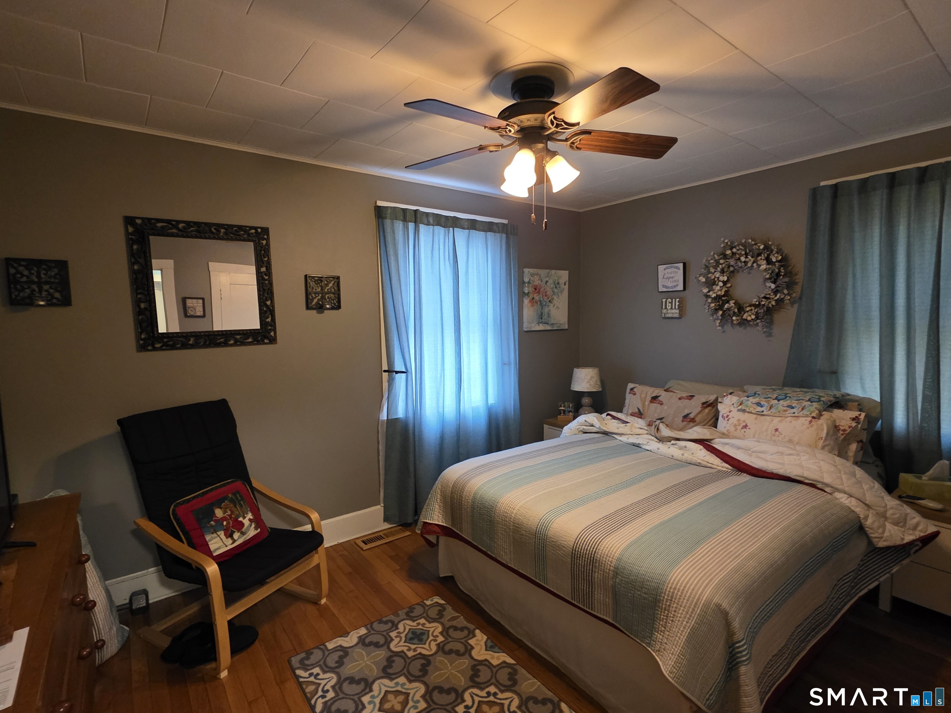 22 Pond Road Franklin, CT 06254 - Photo 18 of 34 a bedroom with a bed and a chandelier