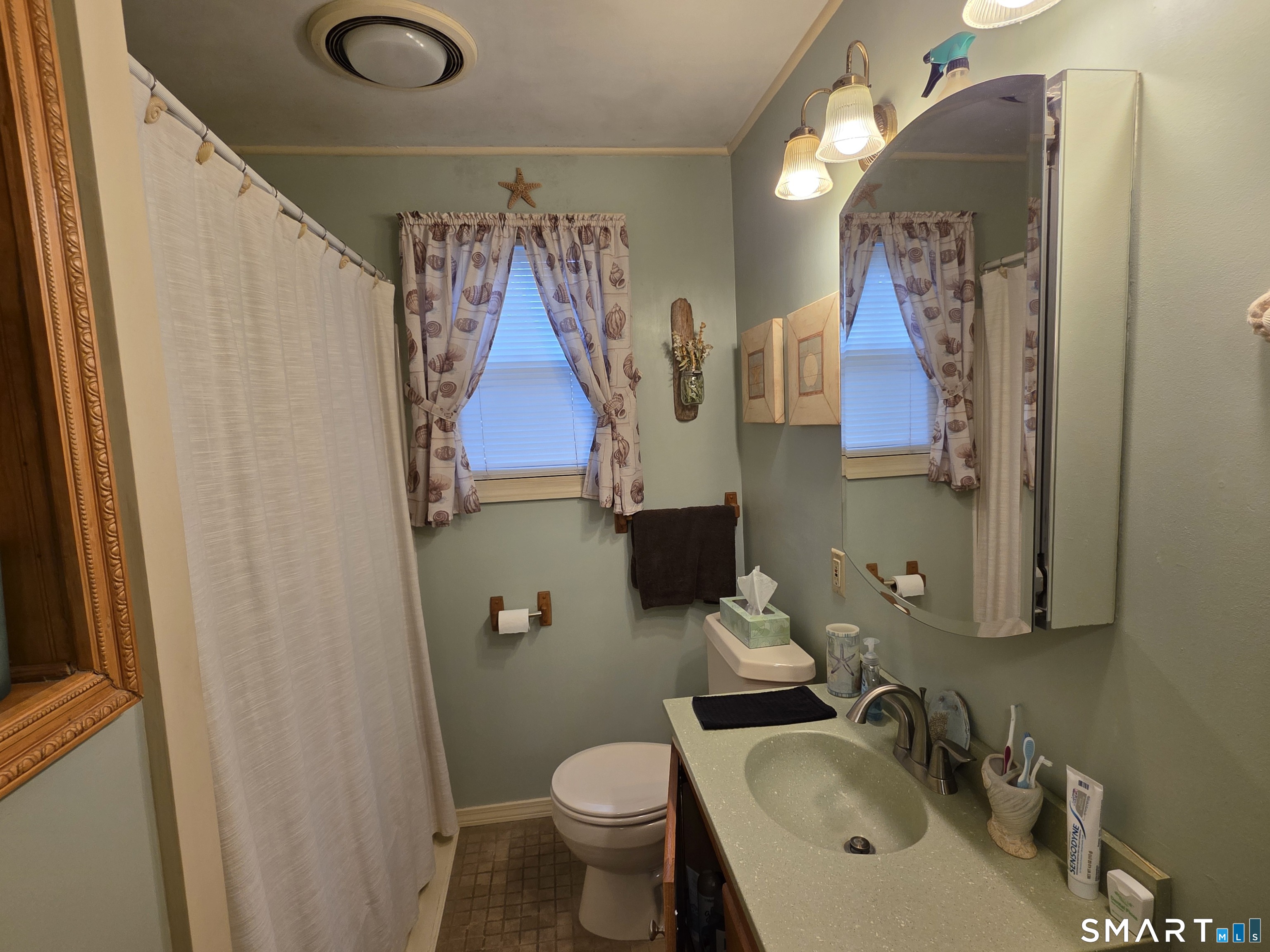 22 Pond Road Franklin, CT 06254 - Photo 19 of 34 a bathroom with a sink and mirror with toilet