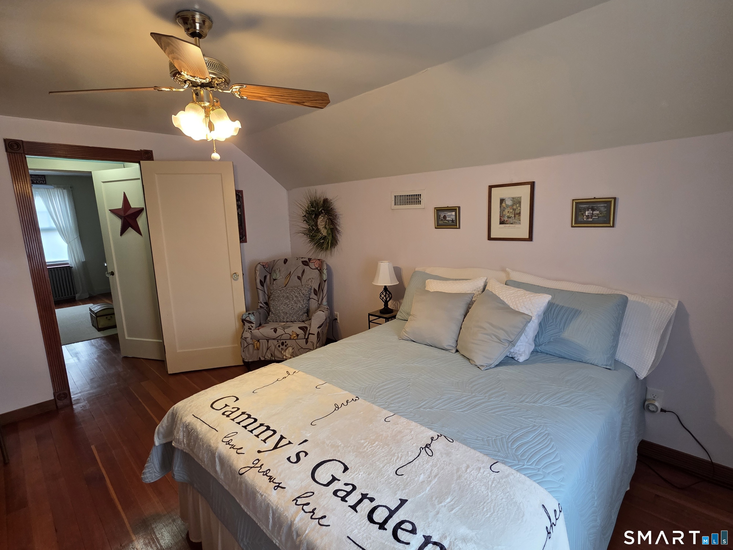 22 Pond Road Franklin, CT 06254 - Photo 22 of 34 a bedroom with a bed and a chandelier