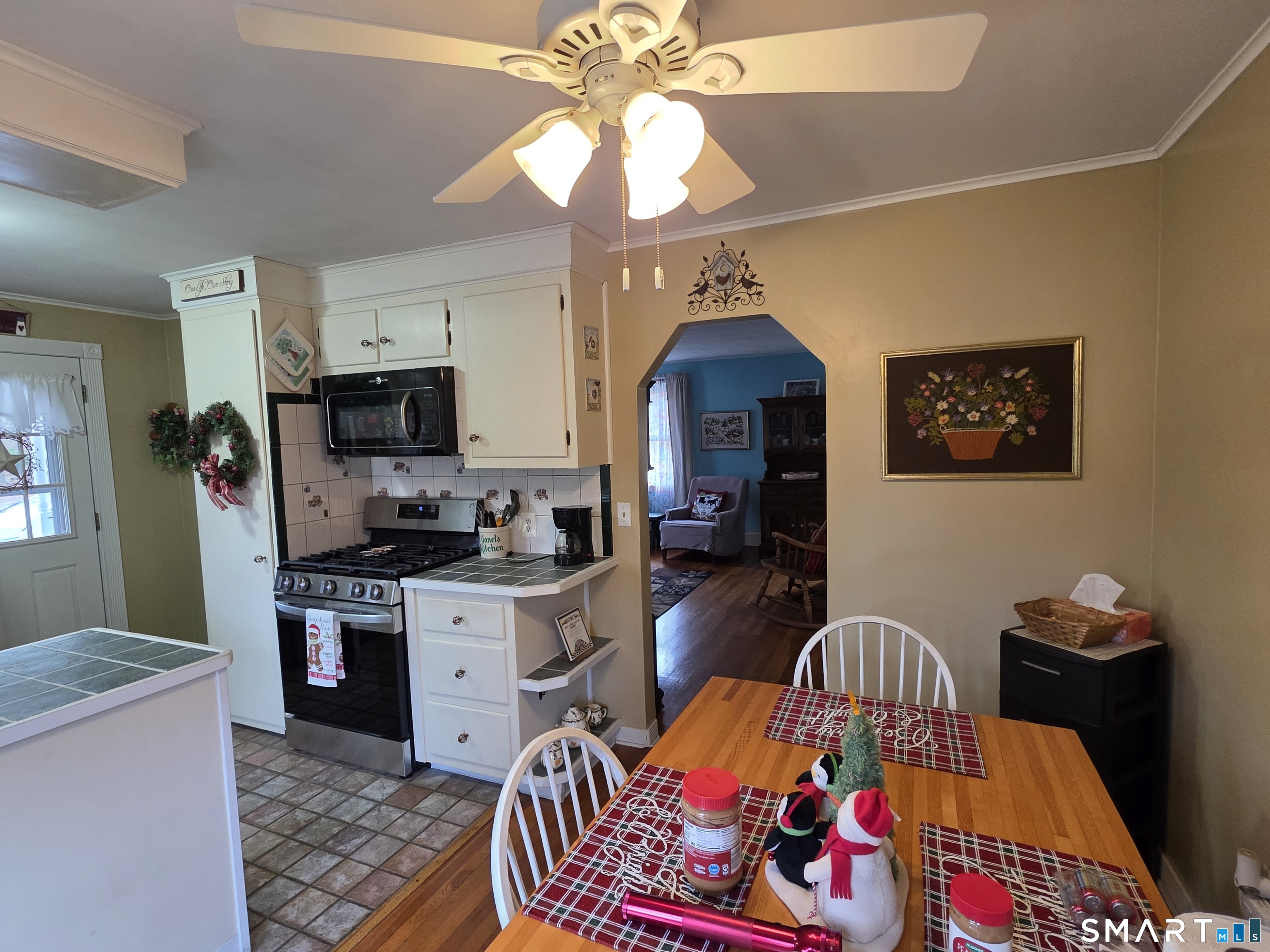 22 Pond Road Franklin, CT 06254 - Photo 9 of 34 a living room with stainless steel appliances furniture a rug and a chandelier
