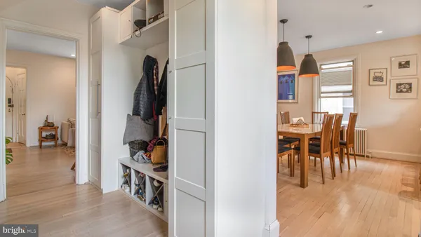 a dining room with furniture window and wooden floor