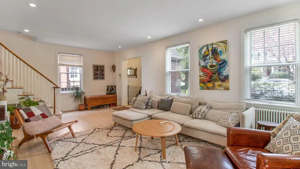a living room with furniture or couch and a potted plant