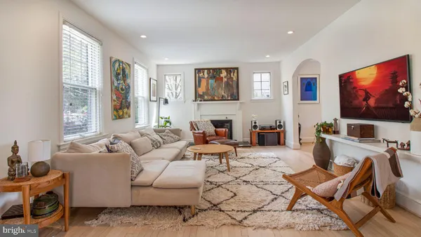 a living room with furniture and wooden floor