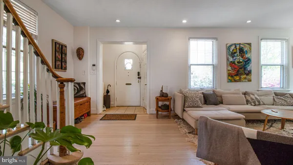 a kitchen with stainless steel appliances kitchen island granite countertop a table chairs and a refrigerator