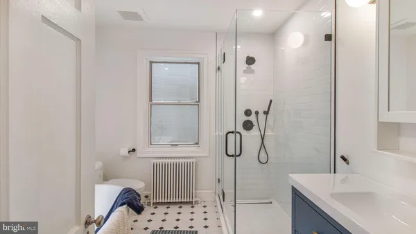 a bathroom with a tub sink vanity and mirror
