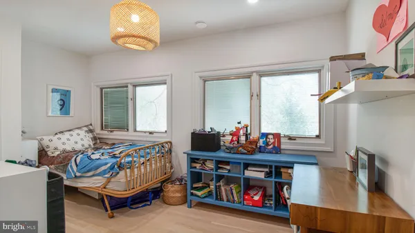 a bedroom with furniture and a book shelf