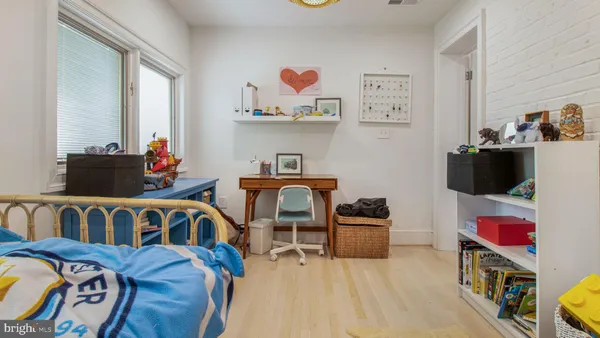a bedroom with furniture and a book shelf