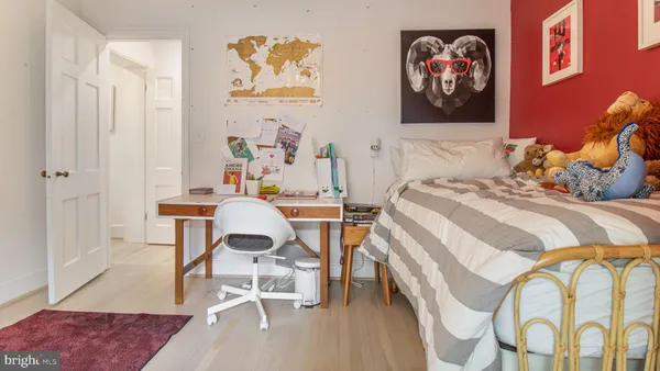 a view of a room with wooden floor and a window