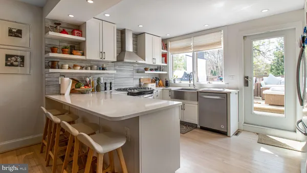 a kitchen with stainless steel appliances granite countertop a stove and a sink