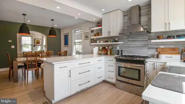 a kitchen with stainless steel appliances kitchen island granite countertop a sink and a refrigerator
