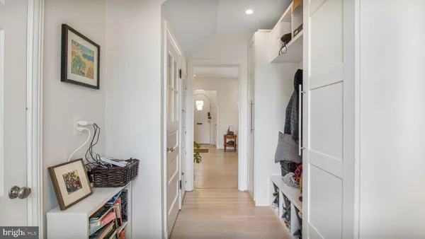 a view of a hallway with wooden shelves