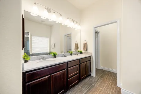a bathroom with a double vanity sink and a mirror