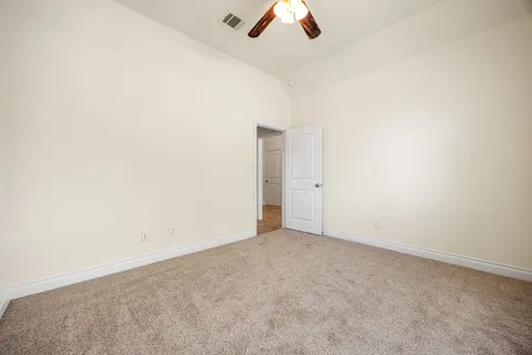 an empty room with a empty space and a ceiling fan