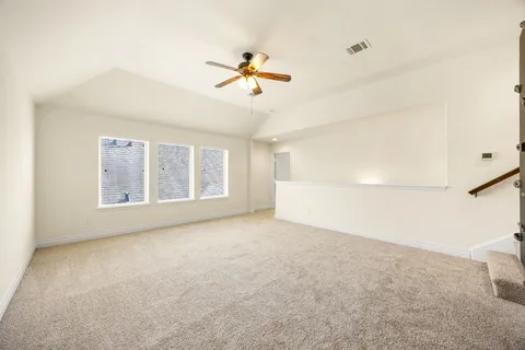a view of a livingroom with a ceiling fan and window