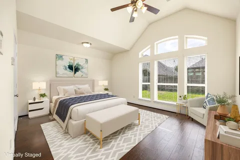 a spacious bedroom with a bed and a large window