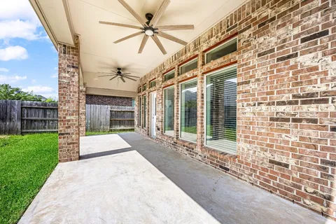 a view of a hall with a large window and wooden floor