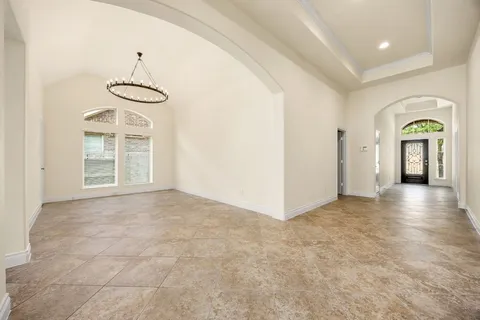 a view of empty room with windows and fan