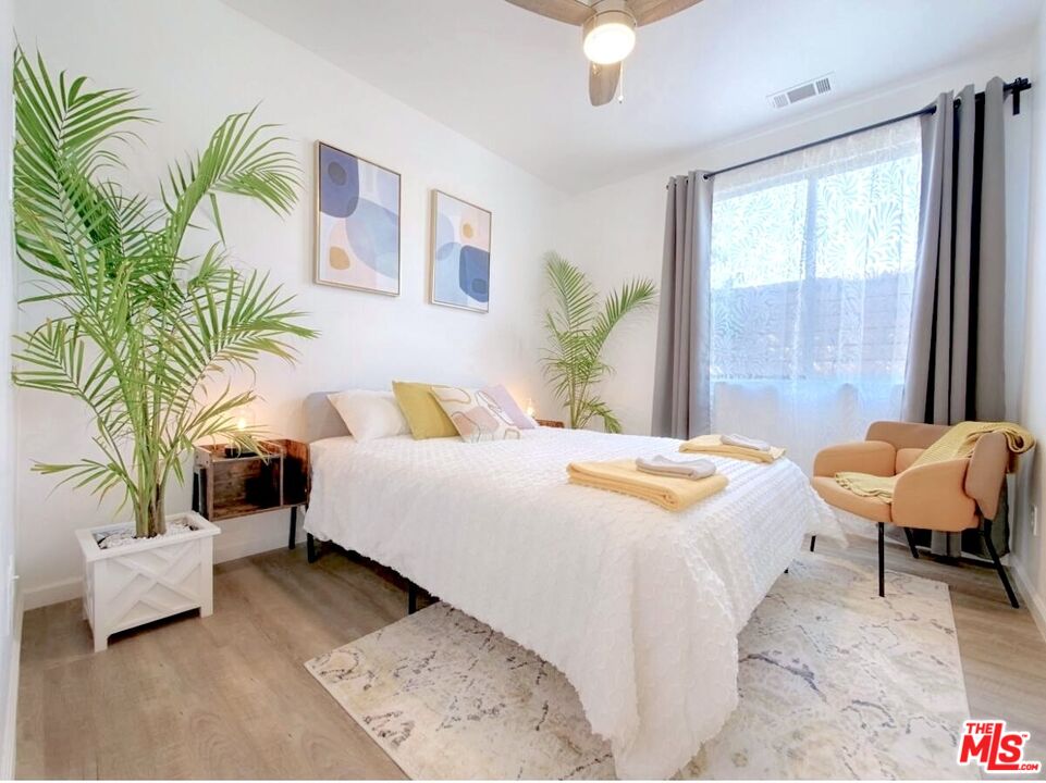 80718 Mountain Mesa Drive Indio, CA 92201 - Photo 12 of 43 a spacious bedroom with a large bed and a potted plant