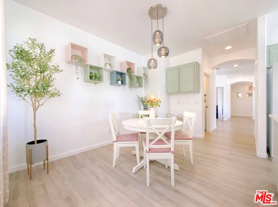 80718 Mountain Mesa Drive Indio, CA 92201 - Photo 13 of 43 a view of a dining room with furniture and wooden floor