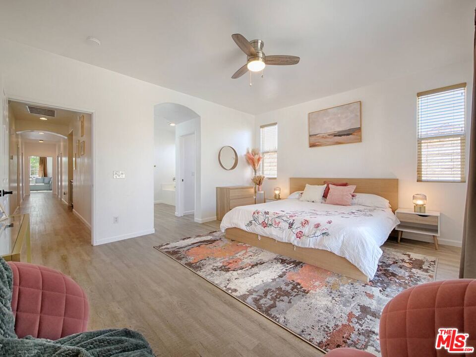 80718 Mountain Mesa Drive Indio, CA 92201 - Photo 14 of 43 a bedroom with a large bed and a chandelier