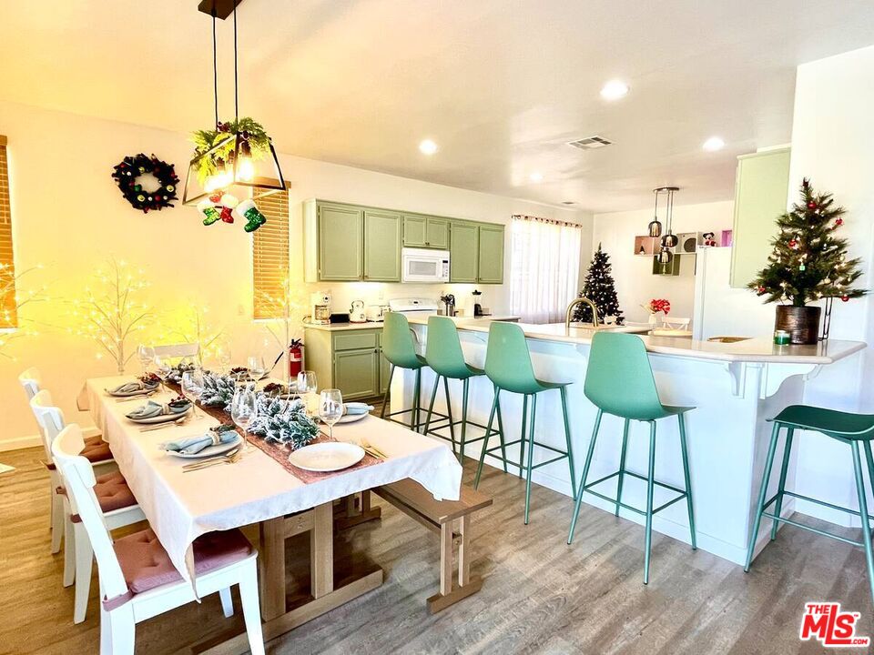 80718 Mountain Mesa Drive Indio, CA 92201 - Photo 20 of 43 a view of a dining room with furniture window and wooden floor