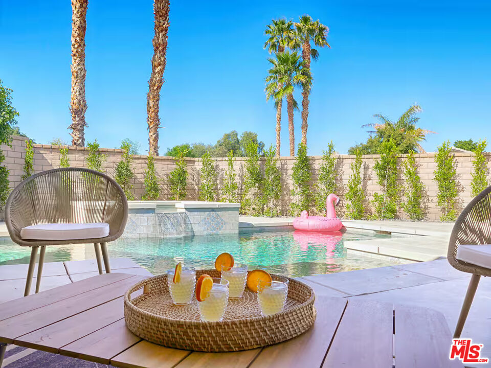 80718 Mountain Mesa Drive Indio, CA 92201 - Photo 2 of 43 a view of a swimming pool with a lounge chairs