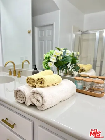 a bathroom with a double vanity sink and a mirror