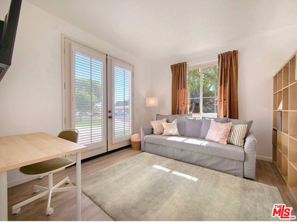 80718 Mountain Mesa Drive Indio, CA 92201 - Photo 28 of 43 a living room with furniture and a floor to ceiling window