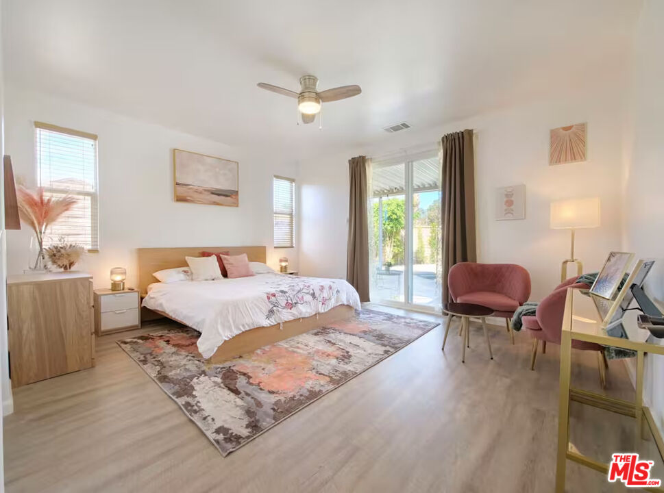 80718 Mountain Mesa Drive Indio, CA 92201 - Photo 29 of 43 a bedroom with a bed and wooden floor