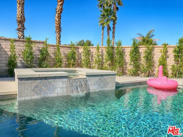 a view of a water fountain and a bench