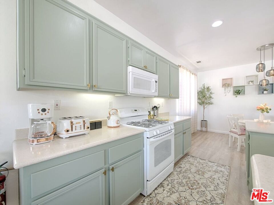 80718 Mountain Mesa Drive Indio, CA 92201 - Photo 6 of 43 a kitchen with a sink cabinets and window