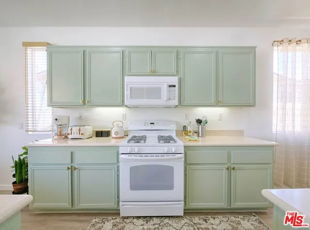 a kitchen with sink cabinets and window