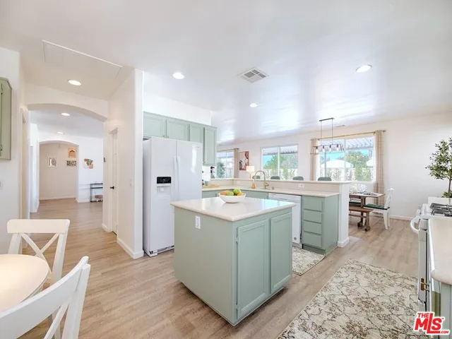 a kitchen with refrigerator cabinets and wooden floor