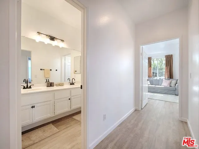 a en suite bathroom with a granite countertop sink and a mirror
