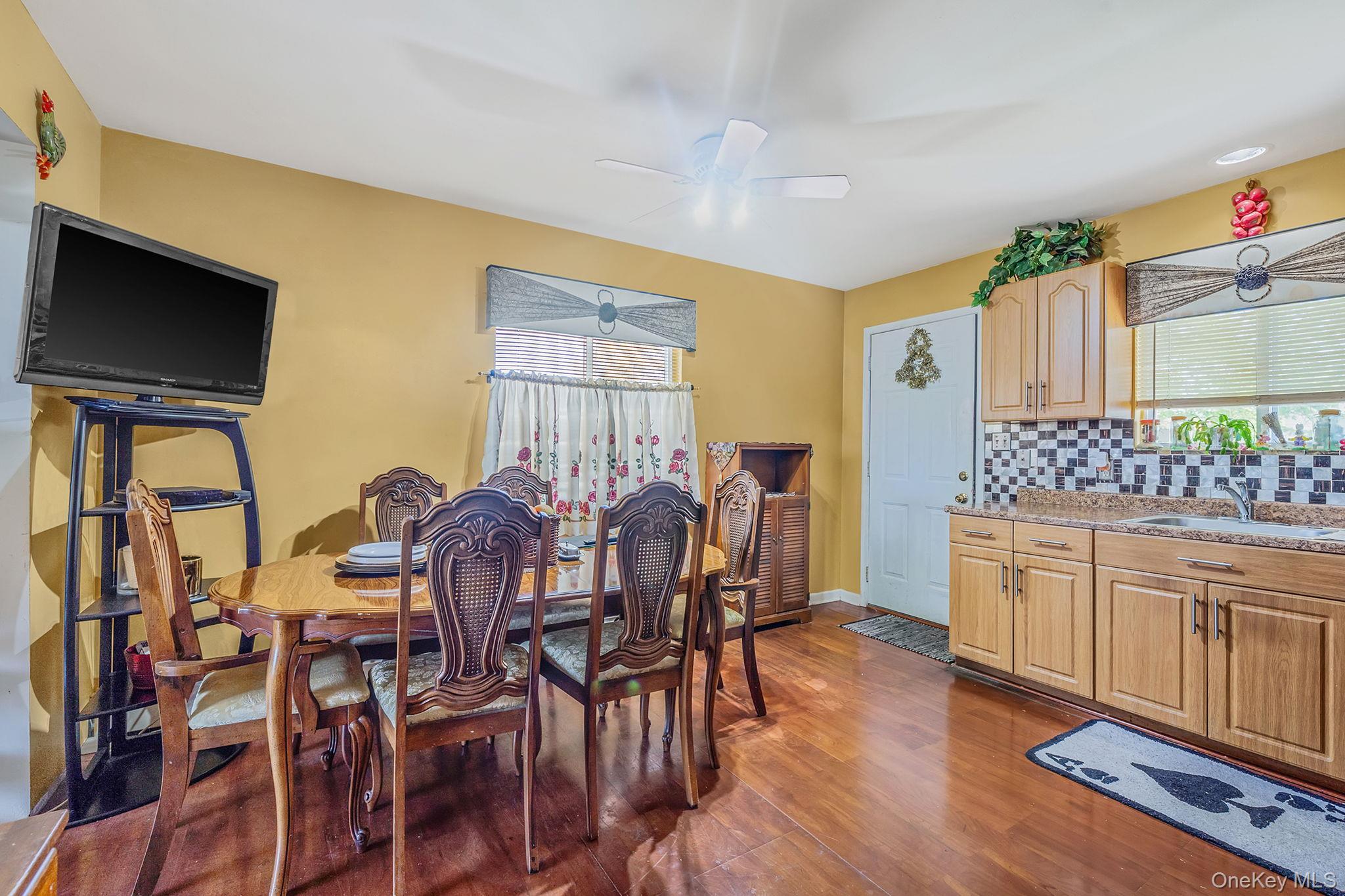 1169 Little E Neck Road West Babylon, NY 11704 - Photo 7 of 28 a view of a dining room with furniture and wooden floor