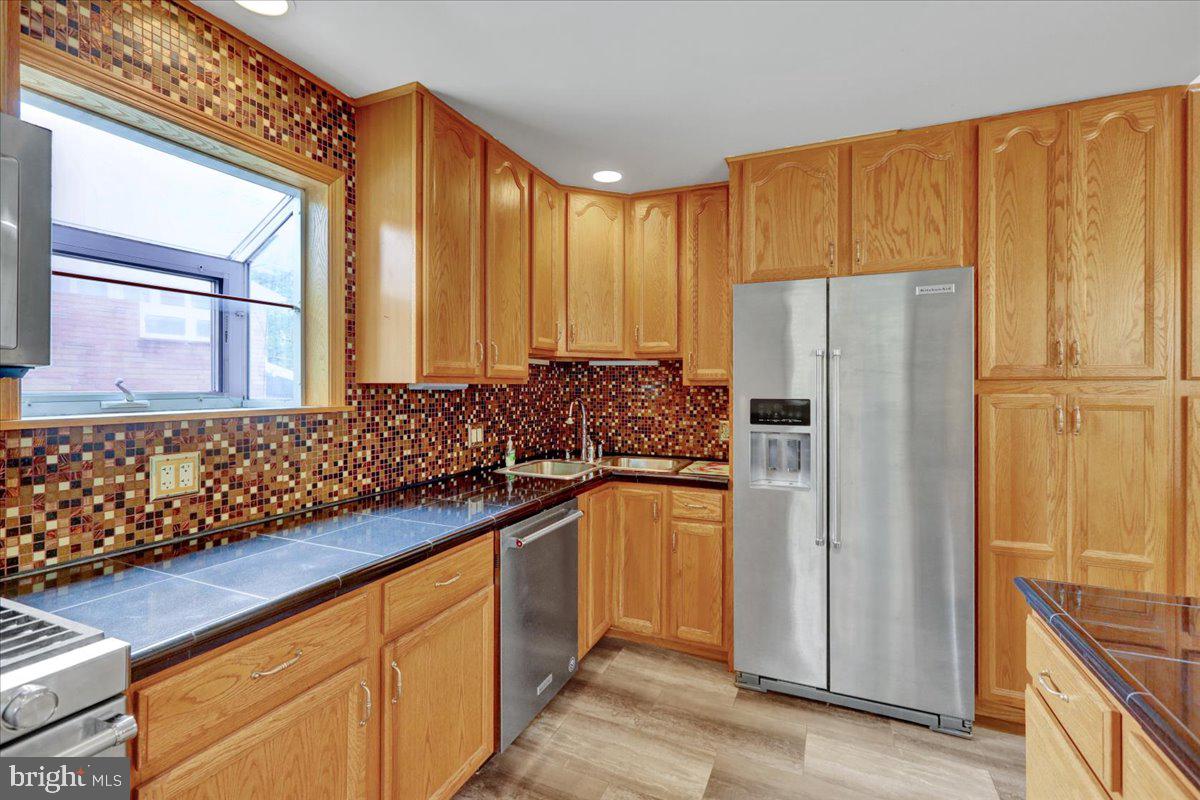 2304 Alsace Road Reading, PA 19604 - Photo 16 of 38 a kitchen with stainless steel appliances granite countertop a refrigerator and a sink