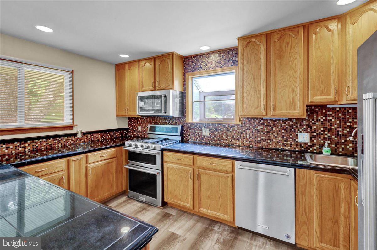 2304 Alsace Road Reading, PA 19604 - Photo 17 of 38 a kitchen with granite countertop a sink stove and cabinets