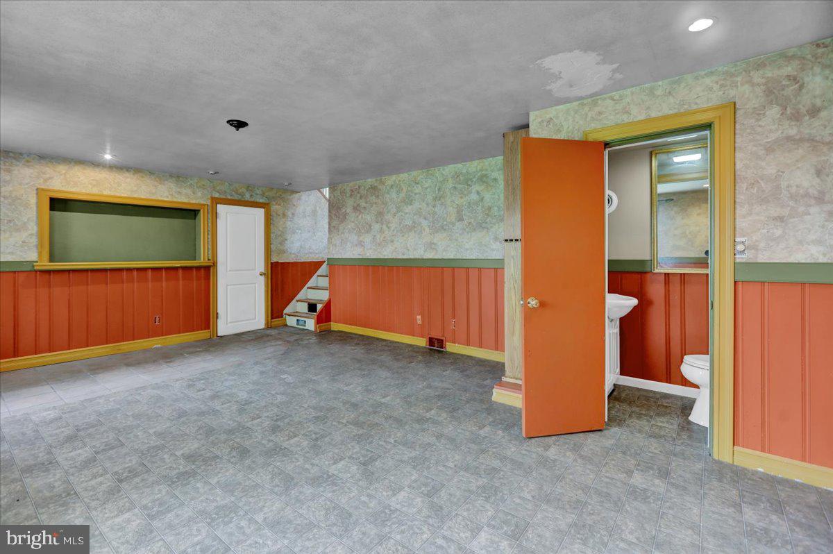 2304 Alsace Road Reading, PA 19604 - Photo 31 of 38 a view of an empty room with a fireplace and a projector