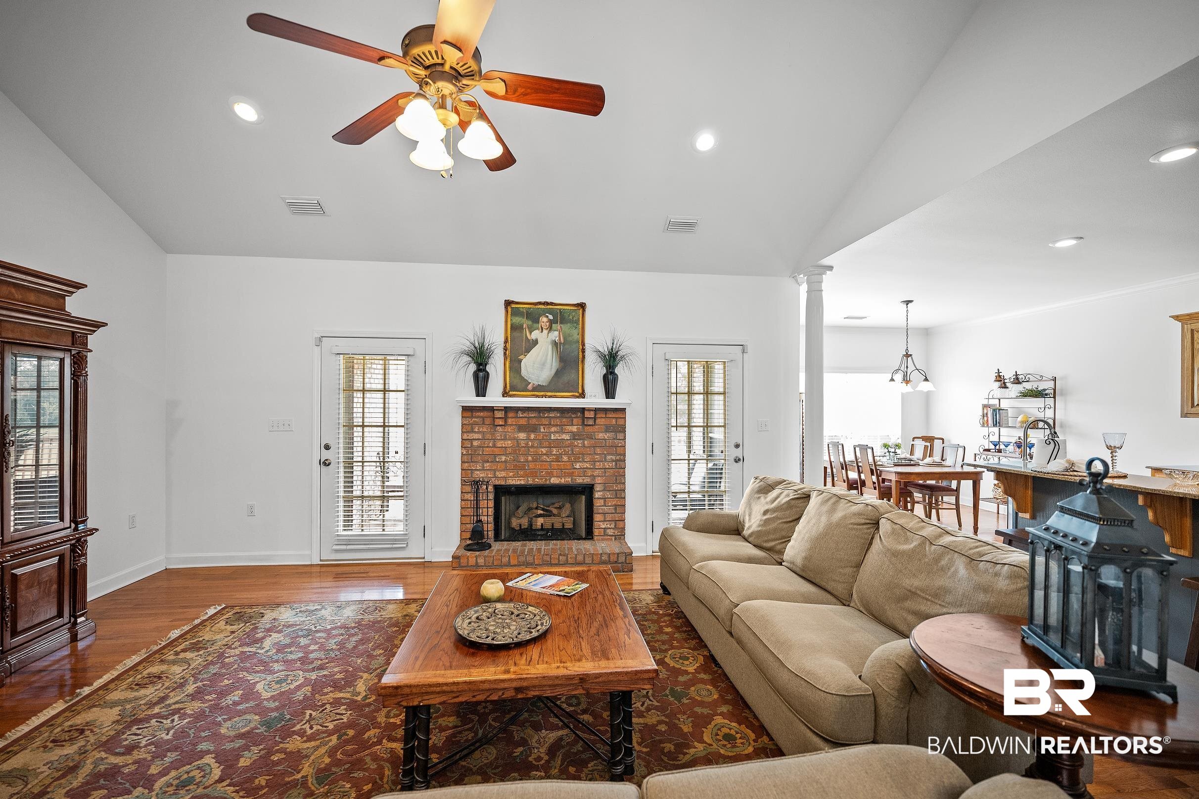197 Morning Ridge Road Monroeville, AL 36460 - Photo 9 of 51 Living area featuring a brick fireplace with hearth, wood-finish flooring, vaulted ceiling, and recessed lighting