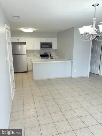 a kitchen with stainless steel appliances a refrigerator sink and microwave