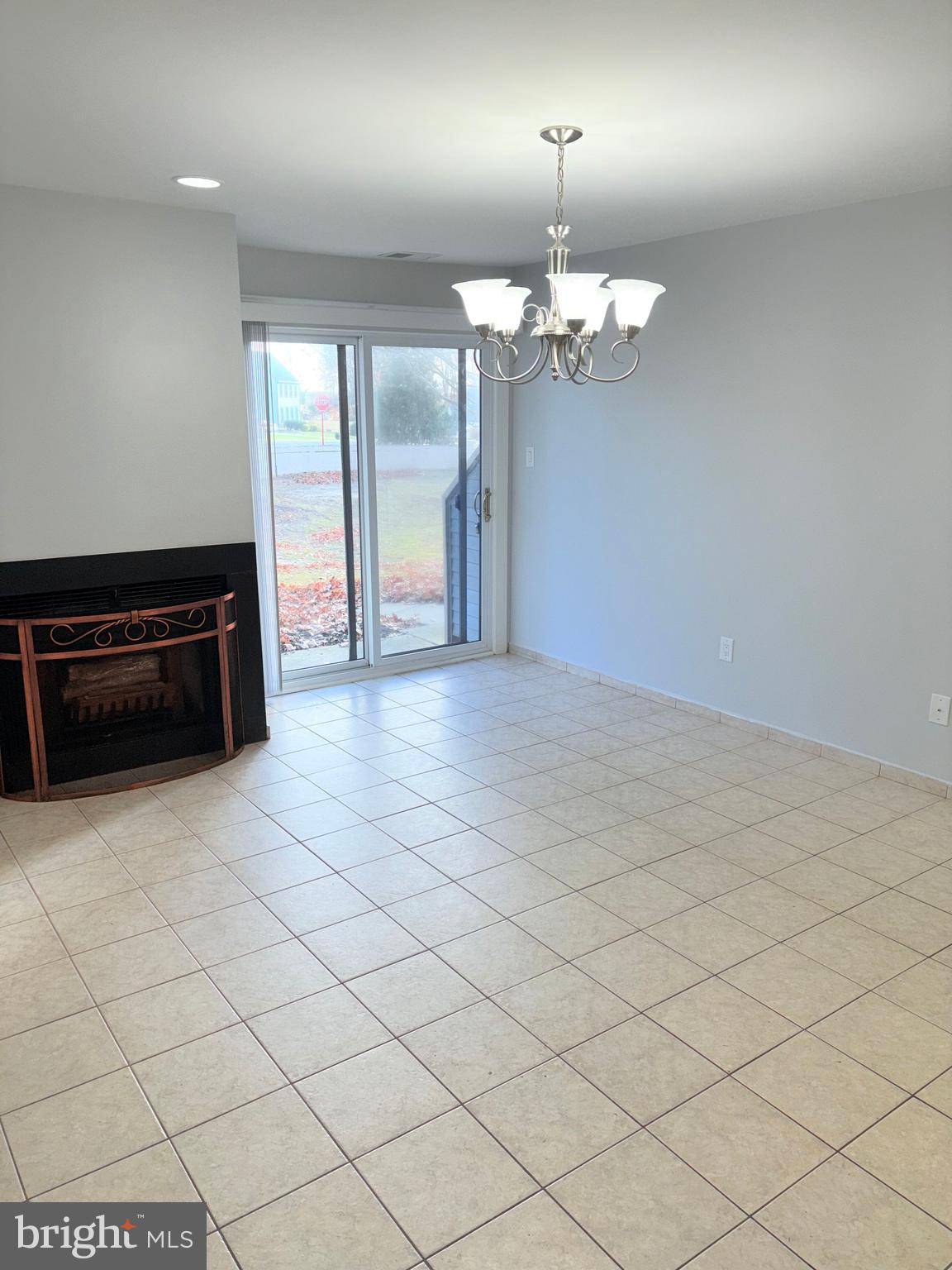 265 Barclay Court West Deptford, NJ 08051 - Photo 5 of 16 an empty room with kitchen view and natural light