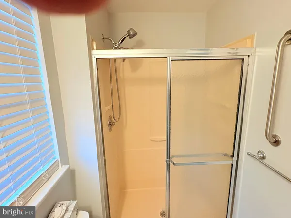 a bathroom with a shower and a glass door